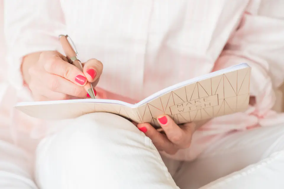A woman writing her thoughts in a notebook